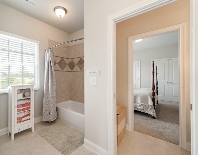 bathroom with tile patterned floors and shower / bath combo with shower curtain