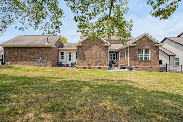 back of house featuring a yard and a patio area