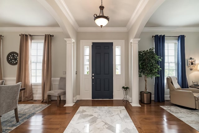 entrance foyer with ornamental molding, decorative columns, and dark hardwood / wood-style floors