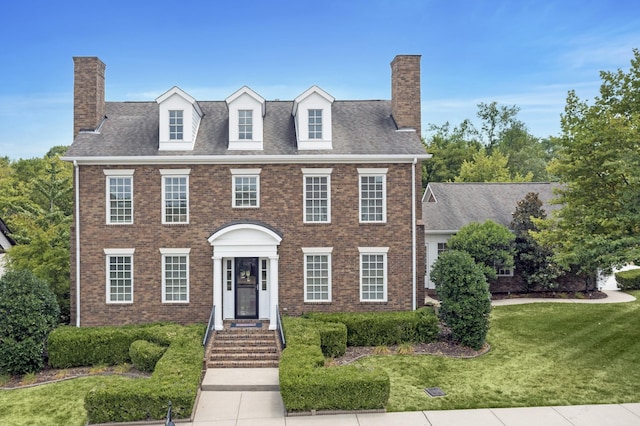 colonial house featuring a front yard