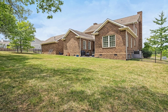 rear view of property with a lawn