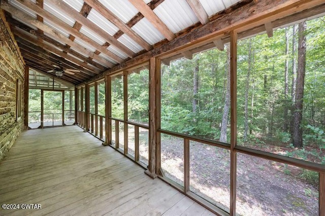 unfurnished sunroom with vaulted ceiling and ceiling fan