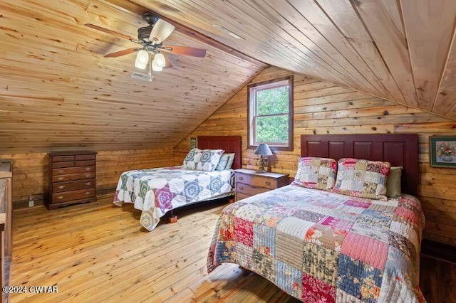 bedroom with wood ceiling, ceiling fan, light hardwood / wood-style floors, vaulted ceiling, and wood walls