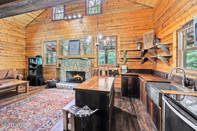 kitchen featuring a center island, dark wood-type flooring, wooden counters, and wood walls