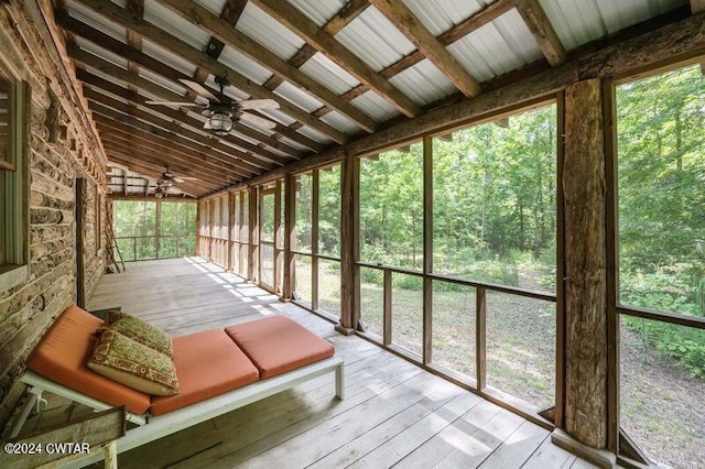 unfurnished sunroom featuring lofted ceiling and ceiling fan