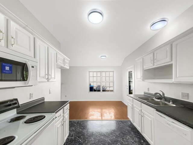 kitchen with sink, white appliances, and white cabinets