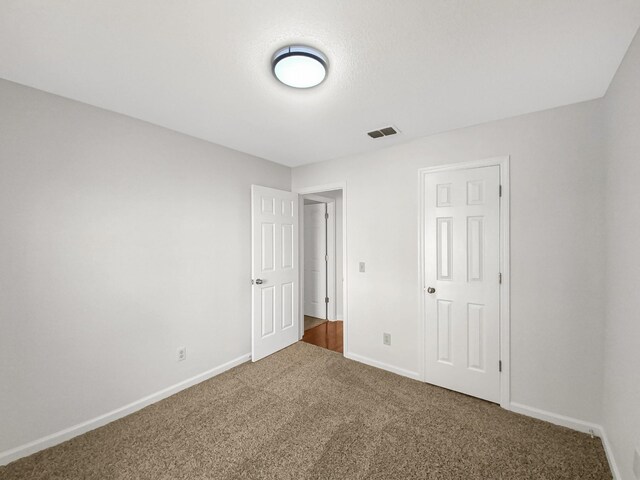 unfurnished bedroom with carpet floors and a closet