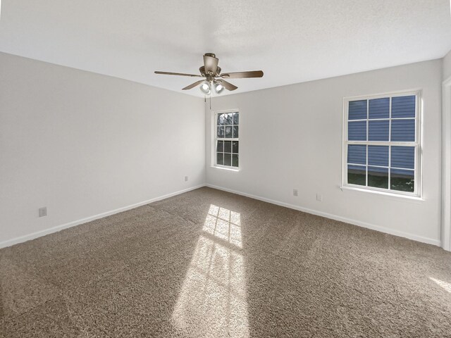 empty room featuring carpet floors and ceiling fan