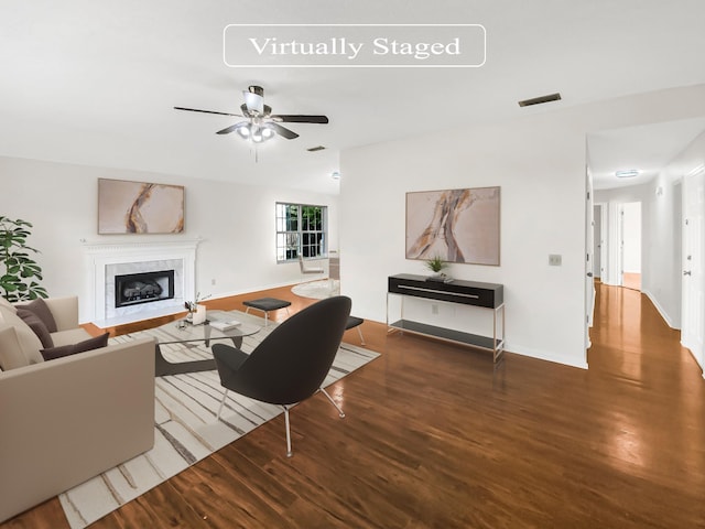 living room with ceiling fan and dark hardwood / wood-style flooring