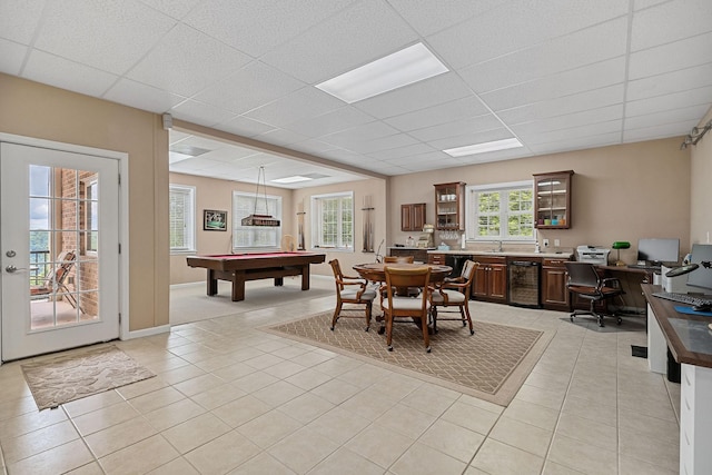 dining space featuring pool table, sink, a drop ceiling, and light tile patterned floors