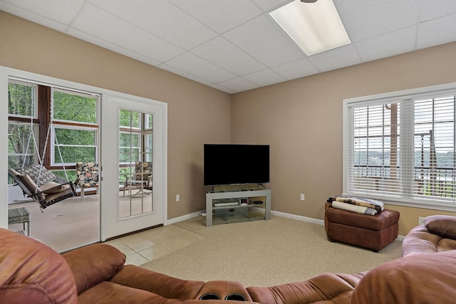 living room featuring a paneled ceiling and light colored carpet