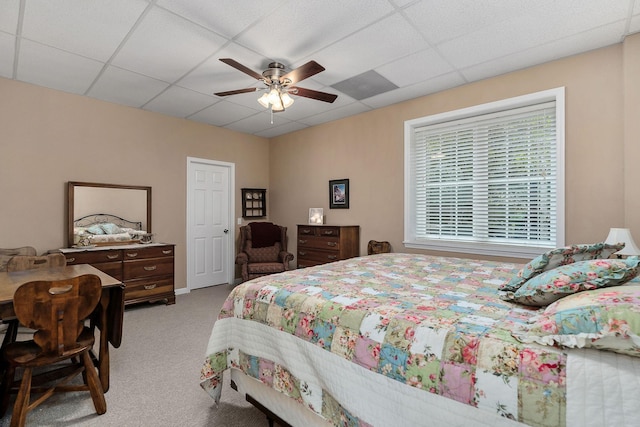 carpeted bedroom featuring a paneled ceiling and ceiling fan