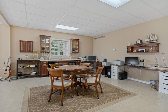 tiled dining area with a drop ceiling