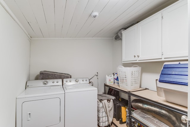 laundry area featuring cabinets, wooden ceiling, and separate washer and dryer