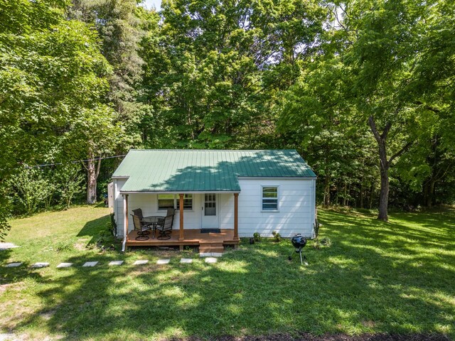 view of front of home with a porch and a front yard