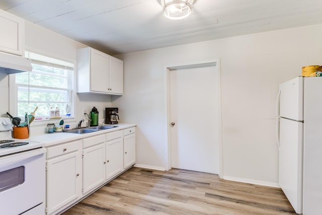 kitchen with white appliances, light hardwood / wood-style flooring, sink, and white cabinets