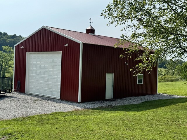 garage featuring a lawn