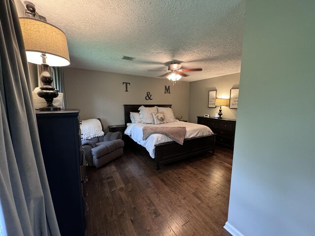 bedroom featuring ceiling fan, a textured ceiling, and hardwood / wood-style flooring