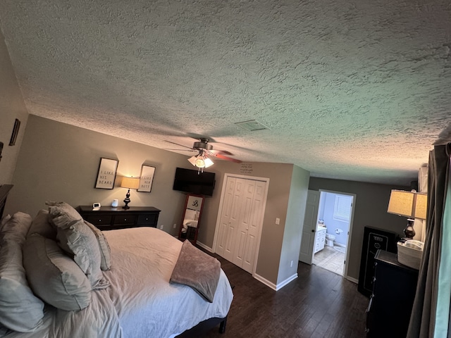 bedroom featuring a closet, ceiling fan, dark hardwood / wood-style flooring, ensuite bath, and a textured ceiling