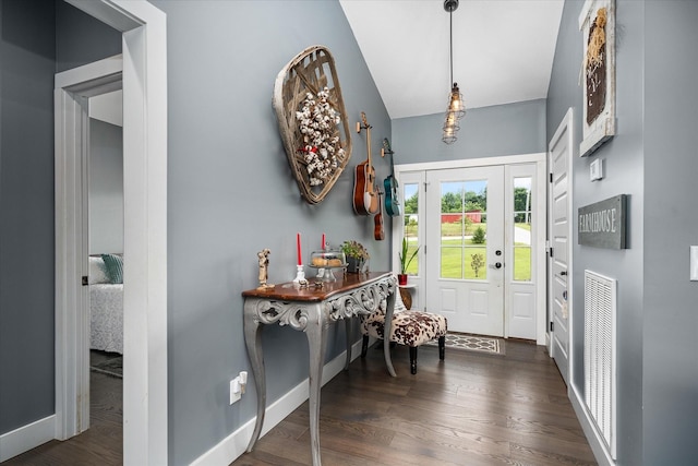 entrance foyer featuring lofted ceiling and dark hardwood / wood-style floors