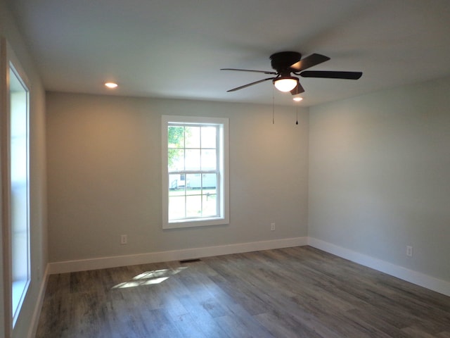 empty room featuring ceiling fan and dark hardwood / wood-style flooring