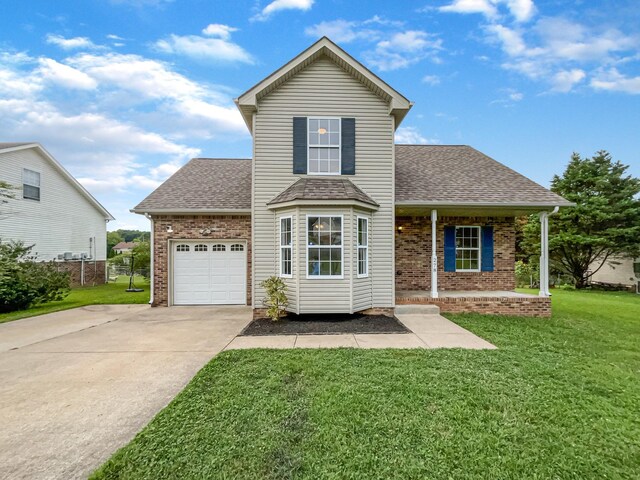 view of front property with a garage, covered porch, and a front lawn