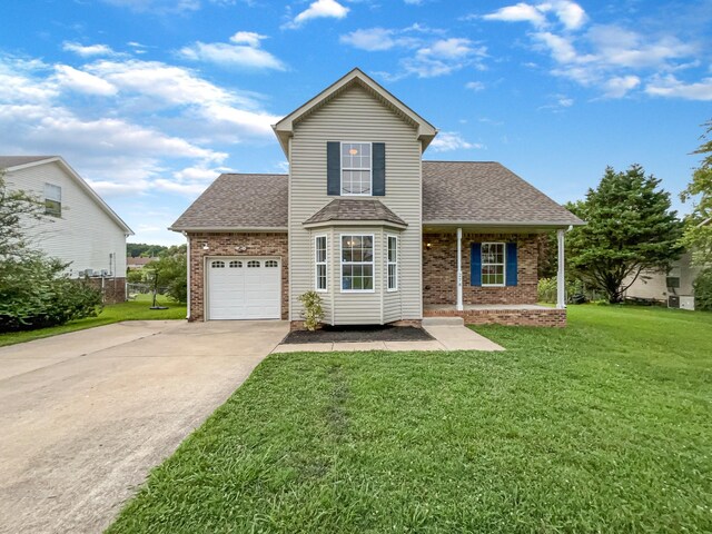 view of property with a garage and a front lawn