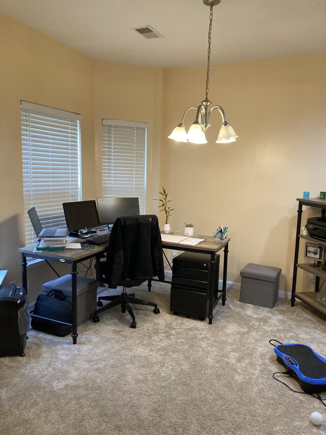 carpeted office space featuring an inviting chandelier