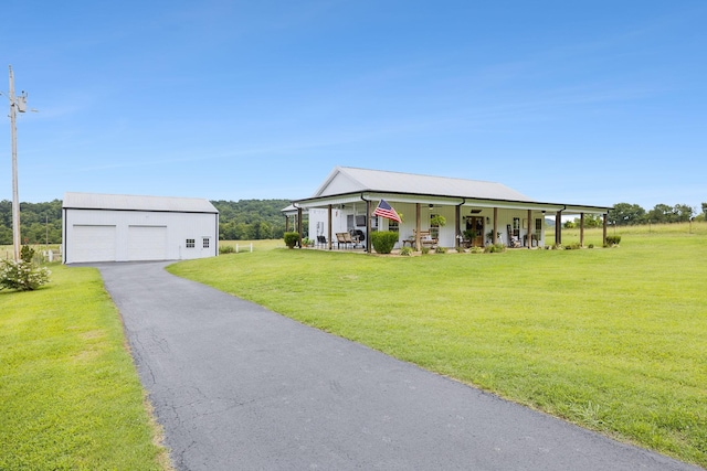 view of front of house with a garage, an outdoor structure, a front lawn, and a porch