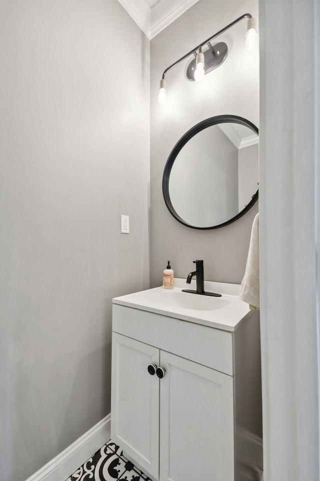 bathroom with ornamental molding and vanity