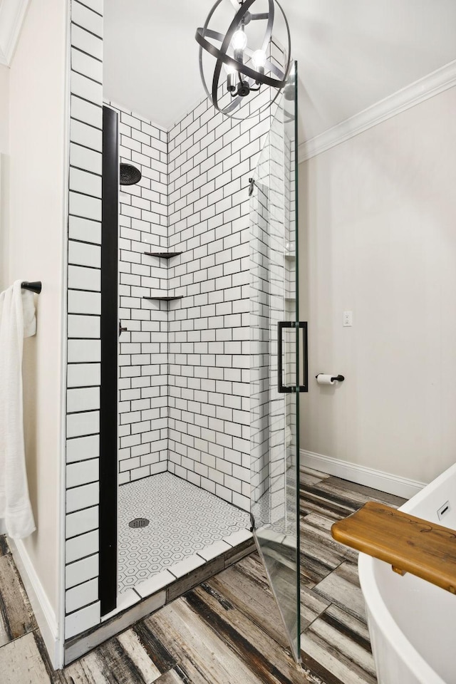 bathroom featuring hardwood / wood-style flooring, ornamental molding, and walk in shower