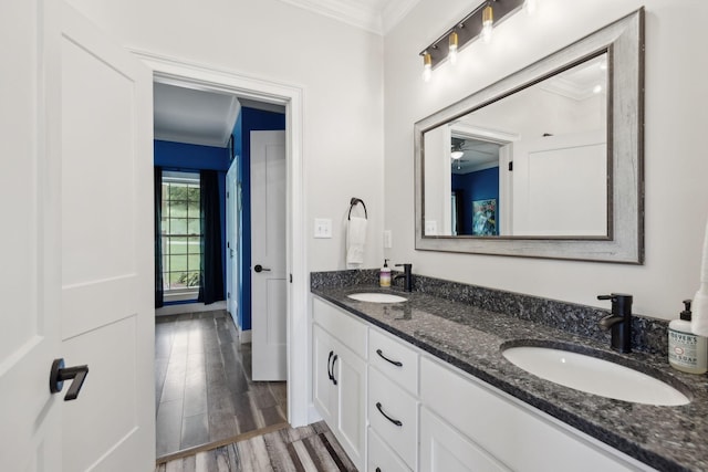 bathroom featuring hardwood / wood-style flooring, ornamental molding, and vanity