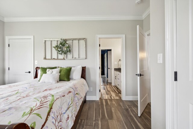 bedroom featuring crown molding, connected bathroom, and dark hardwood / wood-style flooring