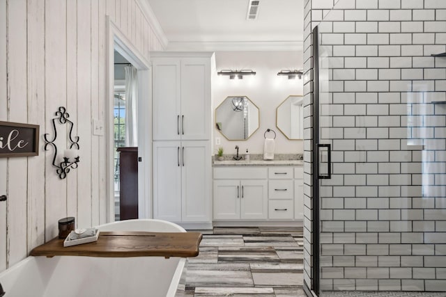 bathroom with crown molding, vanity, wooden walls, and a shower with door