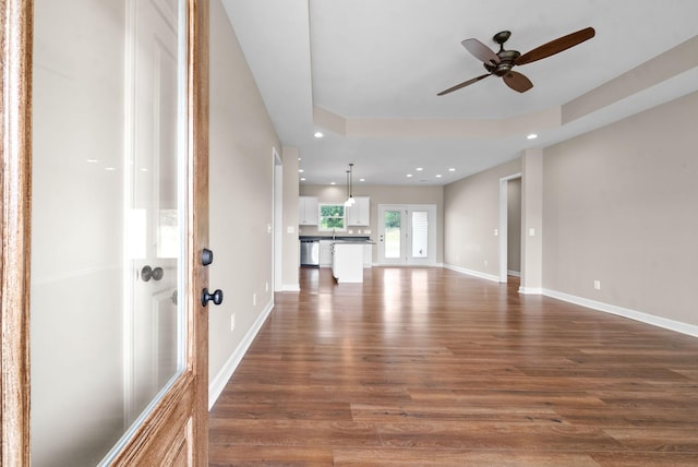 interior space with dark wood-type flooring and ceiling fan