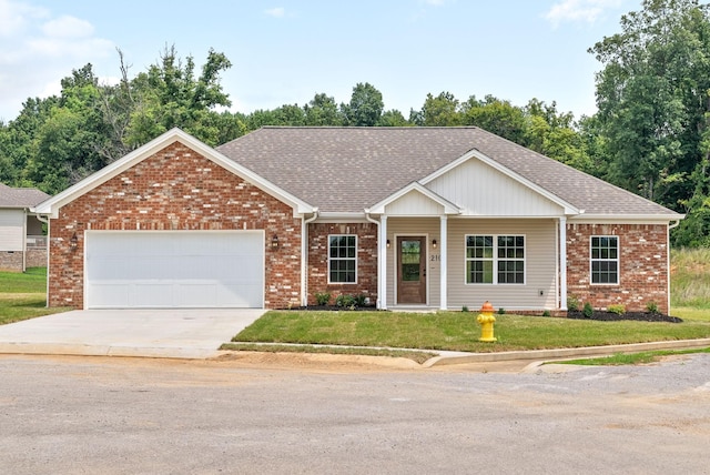 view of front of home featuring a garage and a front lawn