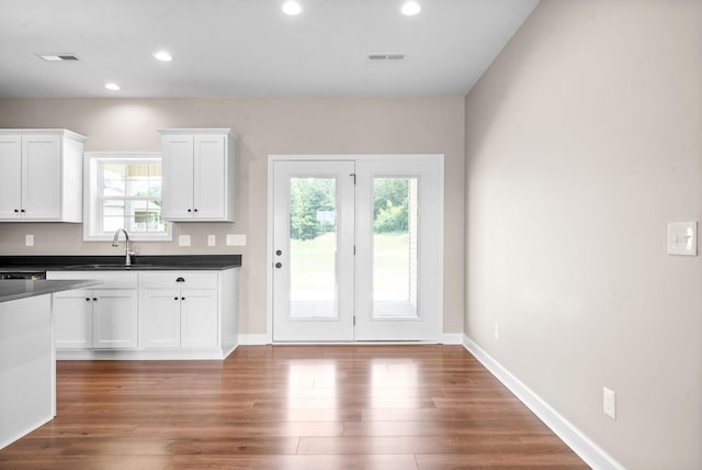 kitchen featuring dark hardwood / wood-style floors, sink, and white cabinets