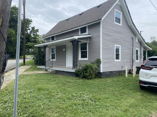 view of front of house featuring a front yard and covered porch