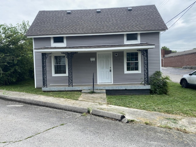 view of front of property with covered porch and roof with shingles