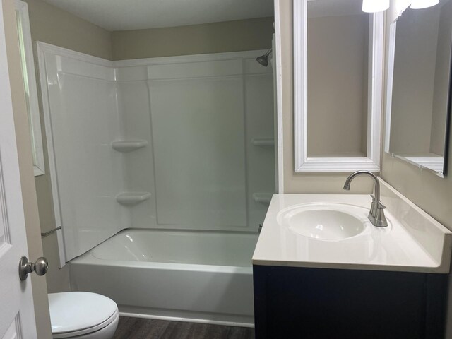 full bathroom featuring toilet, shower / bathing tub combination, vanity, and wood-type flooring