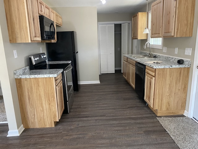 kitchen featuring sink, light stone counters, dark hardwood / wood-style flooring, and black appliances