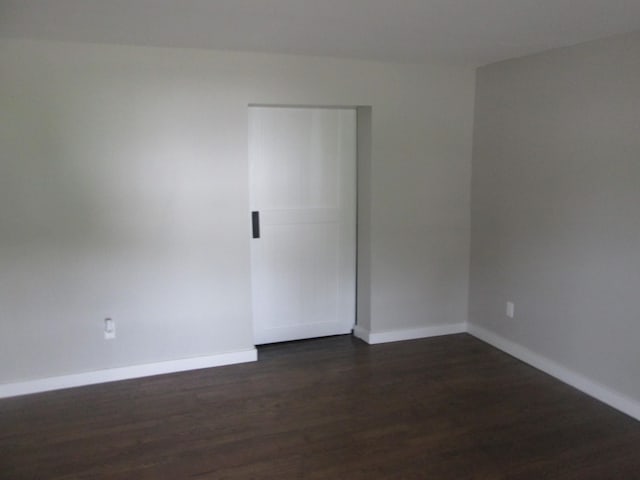 spare room with dark hardwood / wood-style floors