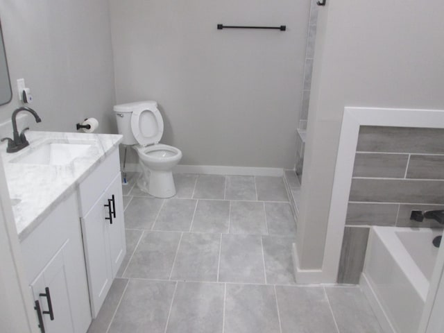 bathroom featuring tile patterned flooring, vanity, a bathing tub, and toilet