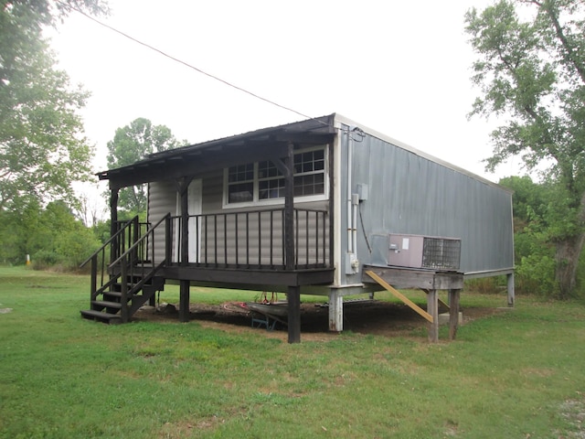 rear view of property featuring a lawn