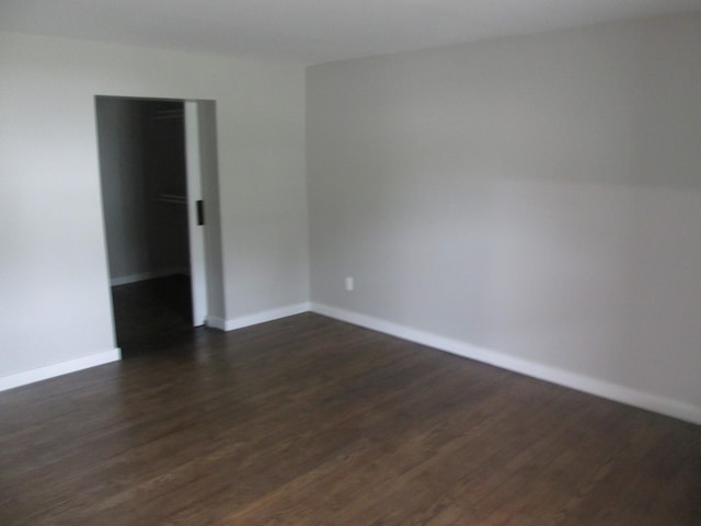 empty room featuring dark wood-type flooring