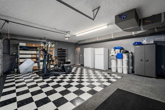 garage with a garage door opener and white fridge