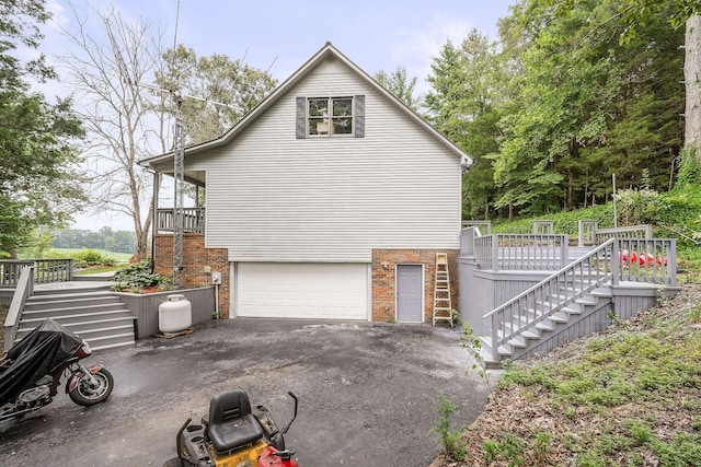 view of property exterior featuring a wooden deck and a garage