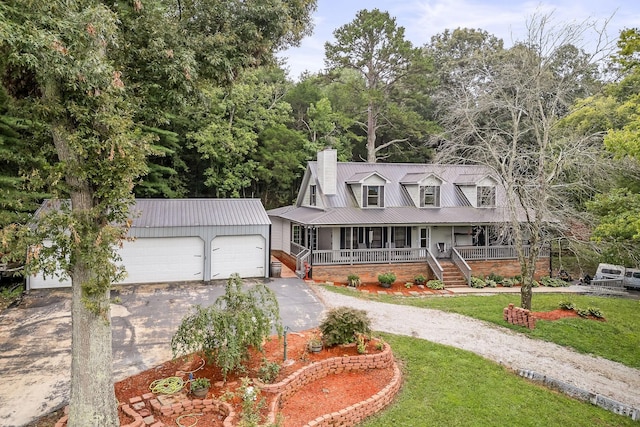 view of front of property featuring a porch, a garage, and a front lawn