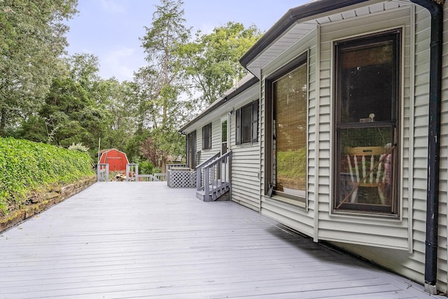 wooden terrace with a storage shed