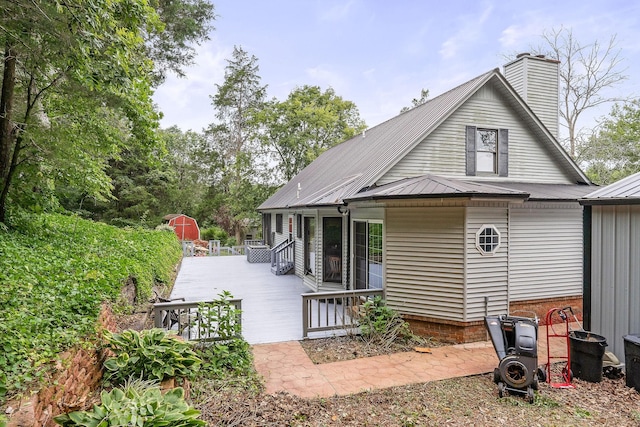 rear view of property with a wooden deck